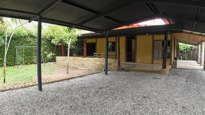 a building with a black roof and a patio at Las Palmeritas de Ojochal in Tortugal