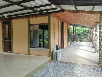 a house with a tv on the outside of it at Las Palmeritas de Ojochal in Tortugal