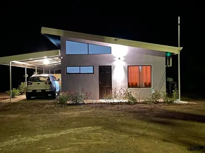a car parked in front of a house at night at Casa Celeste Río Grande in Paquera