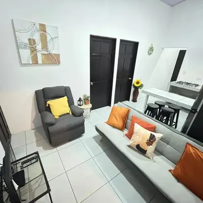 a living room with a couch and a chair at Casa Celeste Río Grande in Paquera