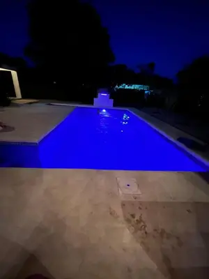 a swimming pool at night with blue illumination at 16 minutes from Tamarindo in Portegolpe
