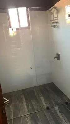 a shower with a glass door in a bathroom at 16 minutes from Tamarindo in Portegolpe