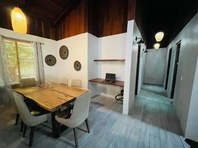 a dining room with a wooden table and chairs at 16 minutes from Tamarindo in Portegolpe