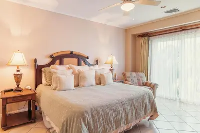 a bedroom with a bed and a chair and a window at CR Luxury Del Mar 5H 2 Bdrm in La Mona