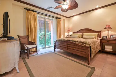 a bedroom with a bed and a chair and a window at CR Luxury Montebello 3F 3 Bdrm in Jacó