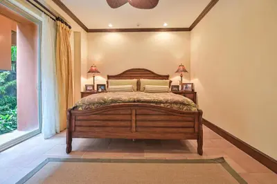 a bedroom with a wooden bed and a window at CR Luxury Montebello 3F 3 Bdrm in Jacó