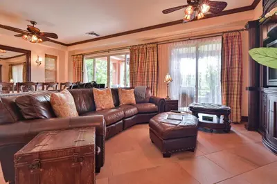 a living room with a leather couch and a table at CR Luxury Montebello 3F 3 Bdrm in Jacó