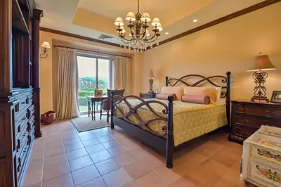 a bedroom with a bed and a dresser and a table at CR Luxury Montebello 3F 3 Bdrm in Jacó