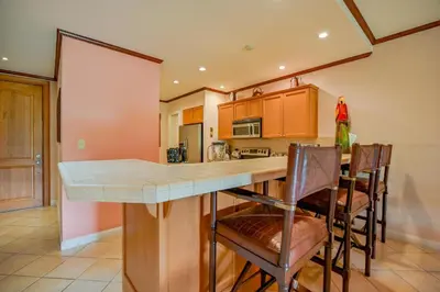 a kitchen with a large island with bar chairs at CR Luxury Del Mar 4Q 2 Bdrm in La Mona