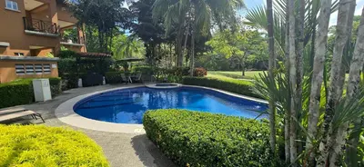 a swimming pool in a yard next to a building at CR Luxury Veranda 7B 2 Bdrm in La Mona