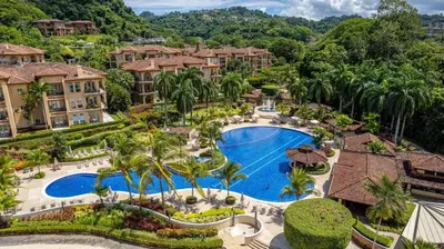 an aerial view of a resort with a pool and palm trees at CR Luxury Veranda 7B 2 Bdrm in La Mona