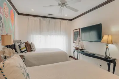 a hotel room with two beds and a tv at CR Luxury Altavista 2A 3 Bdrm in La Mona