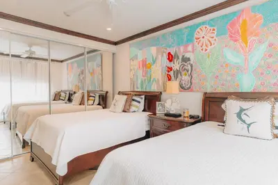 a bedroom with two beds and a painting on the wall at CR Luxury Altavista 2A 3 Bdrm in La Mona