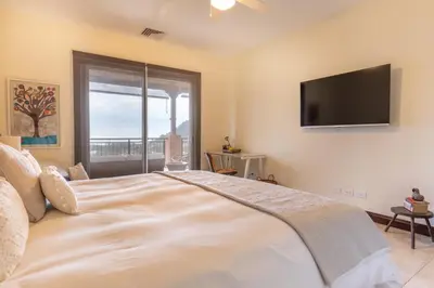 a bedroom with a large bed with a flat screen tv at CR Luxury Altavista 2B 3 Bdrm in La Mona
