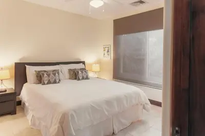 a bedroom with a bed and a large window at CR Luxury Altavista 2B 3 Bdrm in La Mona