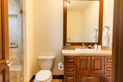 a bathroom with a toilet and a sink and a mirror at CR Luxury Altavista 2B 3 Bdrm in La Mona
