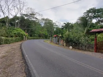 an empty road with a fence on the side of the road at Cabaña Tiquisia in San Lorenzo