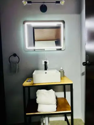 a bathroom with a sink and a mirror at Casa Money in Turrialba