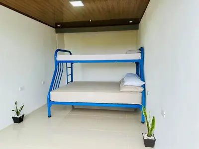 a blue bunk bed in the corner of a room at Casa Money in Turrialba