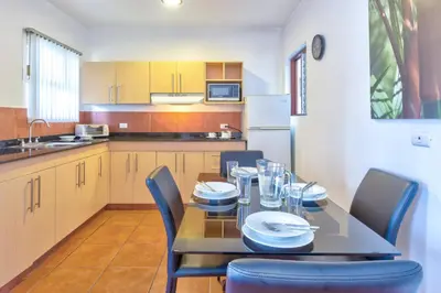 a dining room with a table and chairs in a kitchen at Hotel Residence Inn Suites Cristina in San José