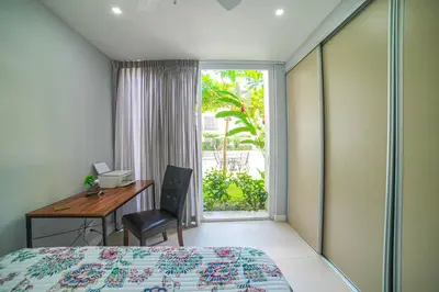a bedroom with a bed and a desk and a window at CR Luxury La Estancia Floresta #05 3 Bdrm in La Mona