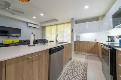 a kitchen with wooden cabinets and a dishwasher at CR Luxury La Estancia Floresta #05 3 Bdrm in La Mona