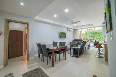 a dining room and living room with a table and chairs at CR Luxury La Estancia Floresta #05 3 Bdrm in La Mona