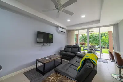 a person laying on a couch in a living room at CR Luxury La Estancia Floresta #05 3 Bdrm in La Mona