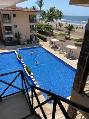 a view of a swimming pool and the beach at JACO HEAVEN Beachfront Penthouse in Jacó