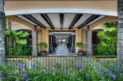 a building with a hallway with plants and flowers at JACO HEAVEN Beachfront Penthouse in Jacó