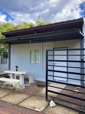 a building with a bench and a table in front of it at Kite Bungalow Bahia Salinas in La Cruz