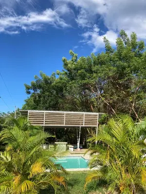 a swimming pool in front of a house at Kite Bungalow Bahia Salinas in La Cruz