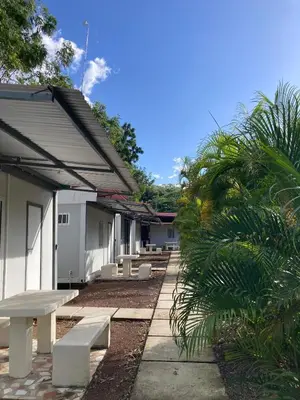 a row of benches in front of a building at Kite Bungalow Bahia Salinas in La Cruz