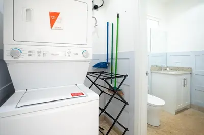 a white kitchen with a refrigerator and a sink at Casa Blue Monkey - Playa Conchal in Brasilito