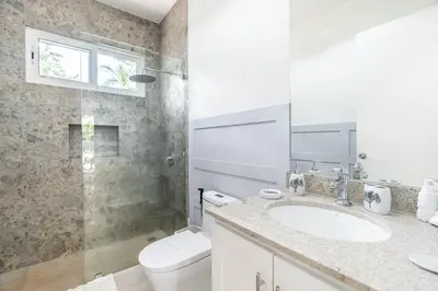 a bathroom with a toilet and a sink and a shower at Casa Blue Monkey - Playa Conchal in Brasilito