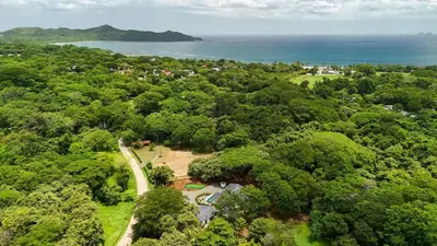 an overhead view of a park with trees and the ocean at Casa Blue Monkey - Playa Conchal in Brasilito