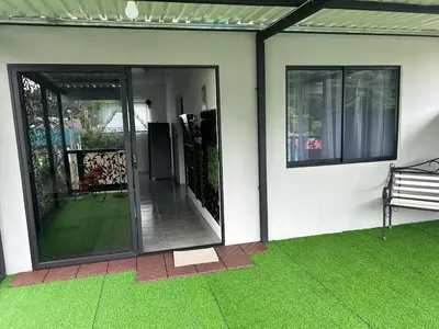 a screened in porch with a bench on a house at Berakah Apartment in Fortuna