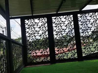 a screened in porch with a patterned window at Berakah Apartment in Fortuna