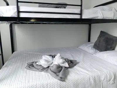a bed with a white flower on top of it at Berakah Apartment in Fortuna