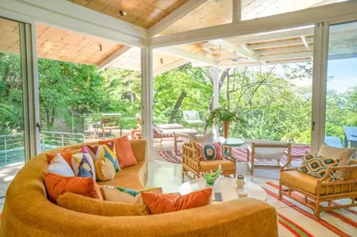 an outdoor living room with a large couch and chairs at Casa AguasPoolYoga deckwalk to Surf Point in Santa Teresa Beach