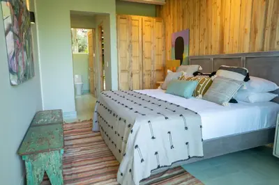 a bedroom with a large bed in a room at Casa AguasPoolYoga deckwalk to Surf Point in Santa Teresa Beach