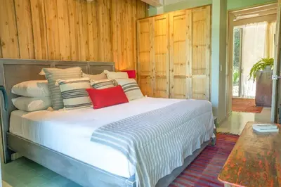 a bedroom with a large white bed with pillows at Casa AguasPoolYoga deckwalk to Surf Point in Santa Teresa Beach