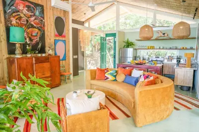a living room with a couch and a table at Casa AguasPoolYoga deckwalk to Surf Point in Santa Teresa Beach