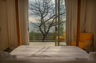a bedroom with a bed and a large window at Casa Aliki, Luxury Beach Home with THE VIEW in Santa Teresa Beach