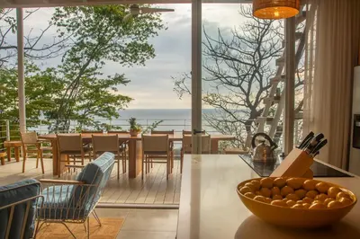 a kitchen with a bowl of fruit on a counter at Casa Aliki, Luxury Beach Home with THE VIEW in Santa Teresa Beach