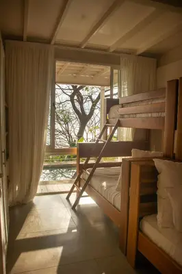 a bedroom with two bunk beds and a window at Casa Aliki, Luxury Beach Home with THE VIEW in Santa Teresa Beach