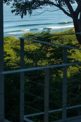 a view of the ocean from a fence at Casa Aliki, Luxury Beach Home with THE VIEW in Santa Teresa Beach