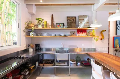 a kitchen with stainless steel counter and shelves at MAR A MAR Nest Bungalow - Pool WalkTo Beach in Santa Teresa Beach