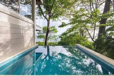 a swimming pool in a house with trees at Casa AtrapasueñosEpic View Surfer's Paradise in Santa Teresa Beach