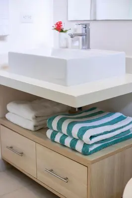 a bathroom with a sink and a towel underneath it at Casa AtrapasueñosEpic View Surfer's Paradise in Santa Teresa Beach